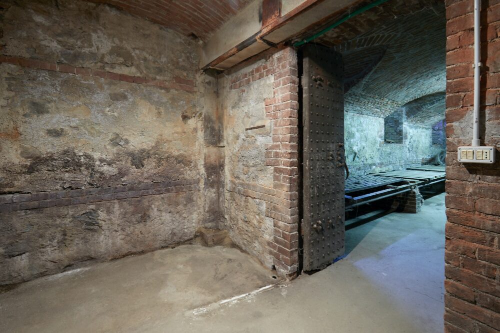 Old, empty basement with brick walls and wooden portal