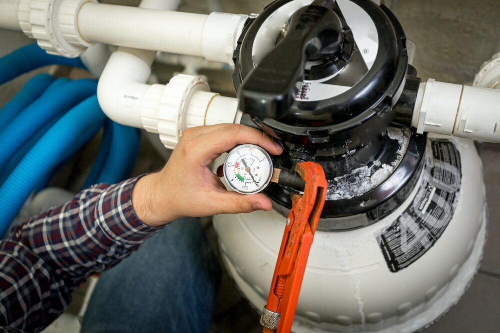 plumber checking manometer on big hydraulic pump